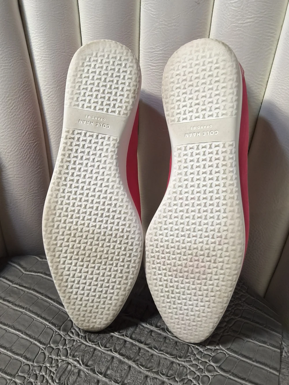 Hot pink Cole Haan Grand Ambition slip-on loafers with glossy patent cap toes.